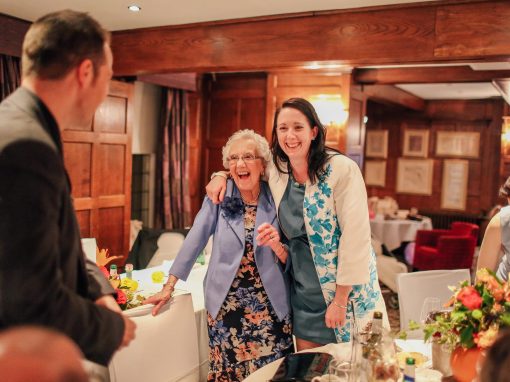 Elderly lady laughing with delight at wedding table magic
